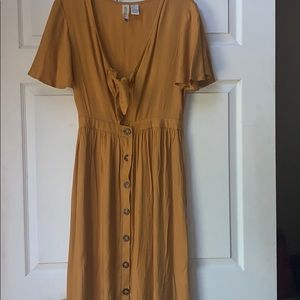 A long mustard yellow sun dress